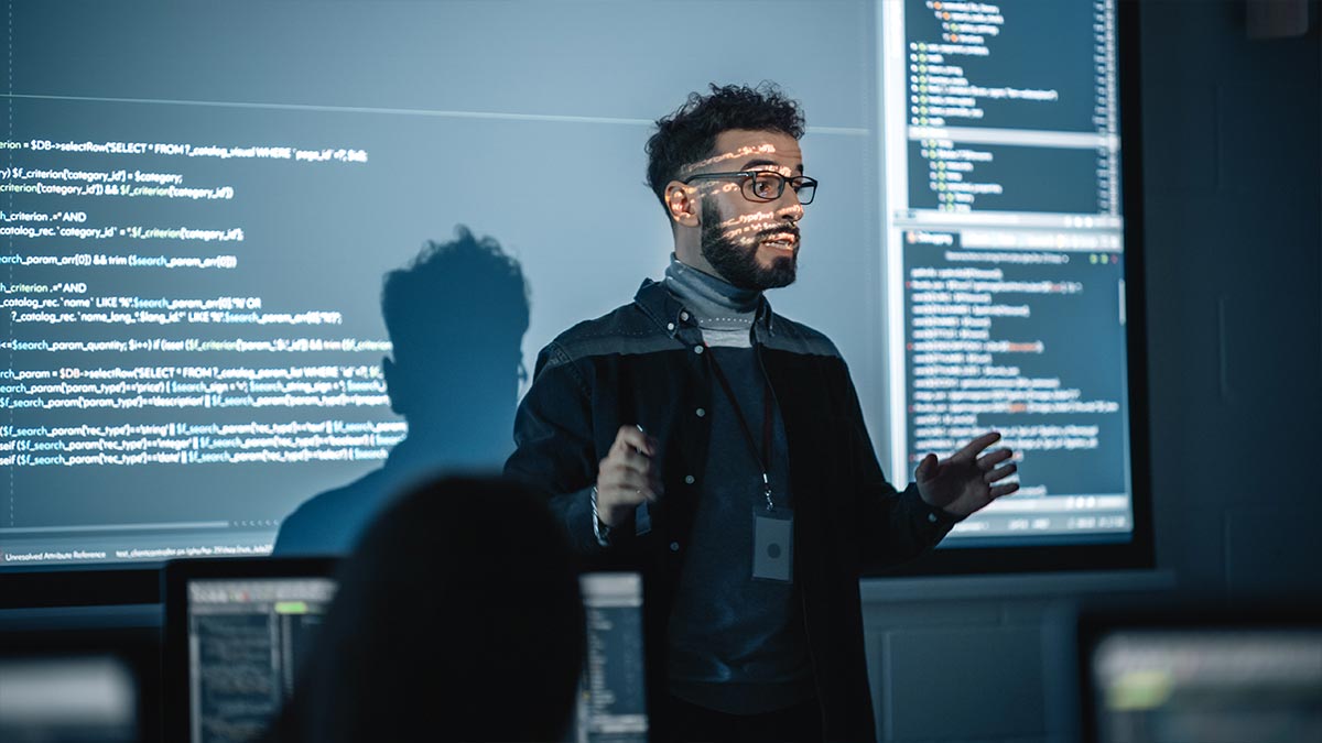 A man giving a presentation on coding