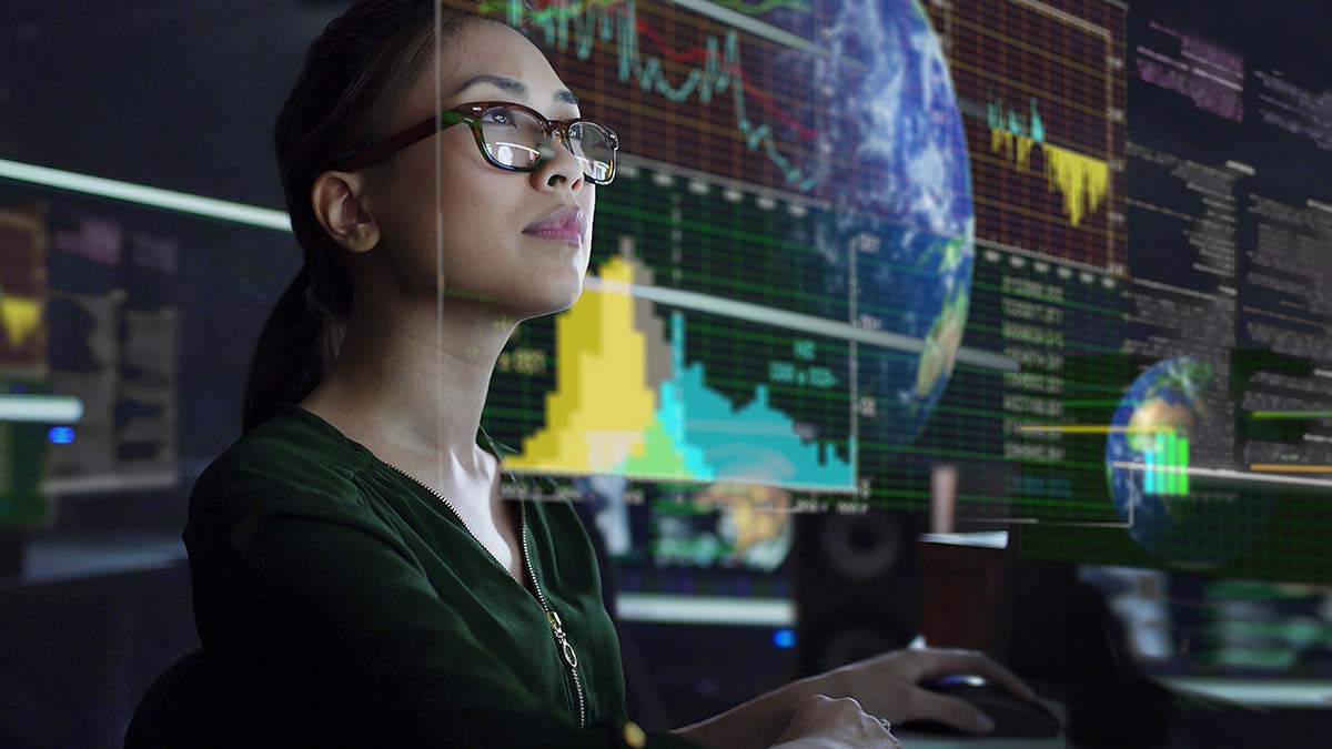 Woman wearing glasses looking at a computer monitor